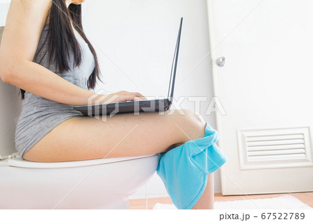 selective of young woman sitting in the toilet working with laptop,Always busy concept 67522789