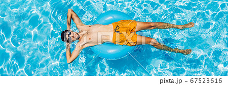 Young man swims in the pool, summer vacation concept BANNER, LONG FORMAT Young man swims in the pool, summer vacation concept BANNER, LONG FORMAT 67523616