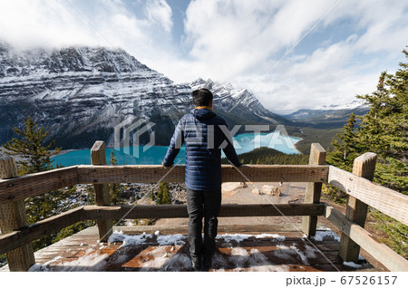 Man standing and looking the view of Peyto lake at Man standing and looking the view of Peyto lake at 67526157
