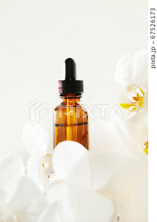 bottle of essential oil with white orchid bottle of essential oil with white orchid 67526173
