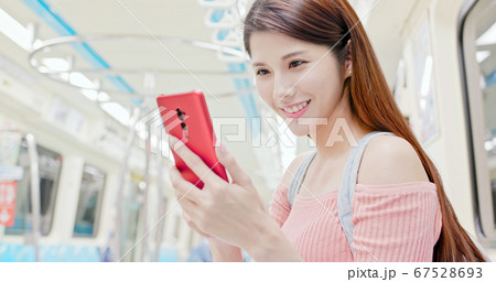 Girl use smartphone in metro 67528693