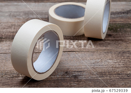 Masking tape on wooden background. Repair tools. 67529339