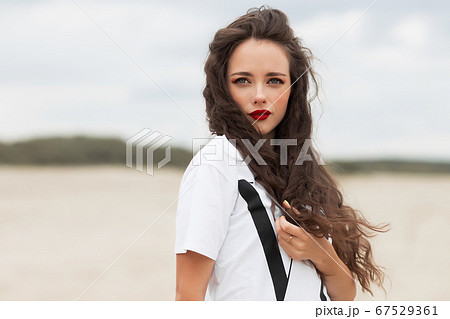 Charming woman on sandy beach 67529361