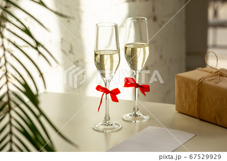 Glasses of sparkling champagne, close up. Warm colored. Celebration event, holidays, drinks concept Glasses of sparkling champagne, close up. Warm colored. Celebration event, holidays, drinks concept 67529929