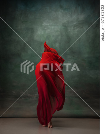 Young graceful tender ballerina on dark green studio background Young graceful tender ballerina on dark green studio background 67531802