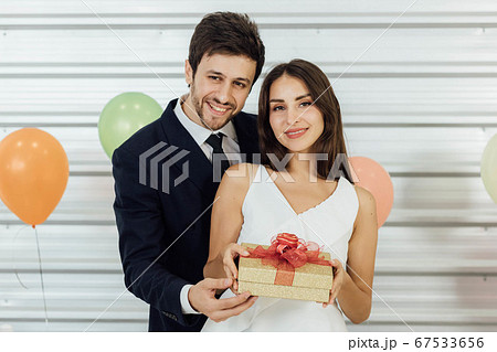 Young couple celebrating new year together, 67533656