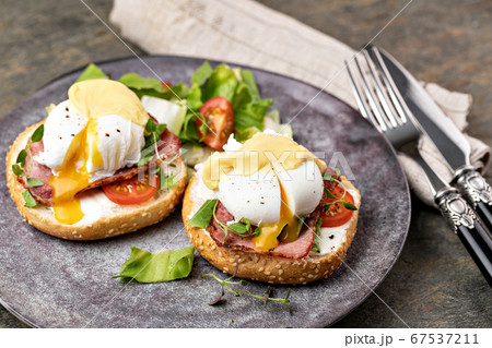 Eggs Benedict with salad Eggs Benedict with salad 67537211