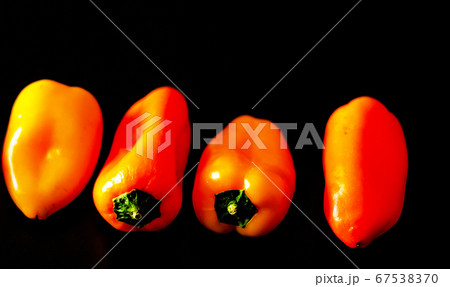 red and yellow peppers on a black background, red and yellow peppers on a black background, 67538370