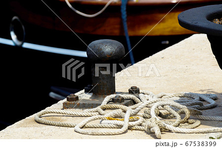 mooring post on the waterfront in a small marina, mooring post on the waterfront in a small marina, 67538399