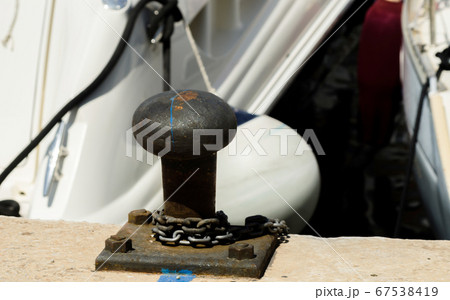 mooring post on the waterfront in a small marina, 67538419