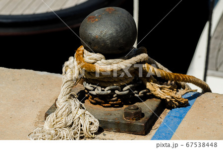mooring post on the waterfront in a small marina, mooring post on the waterfront in a small marina, 67538448