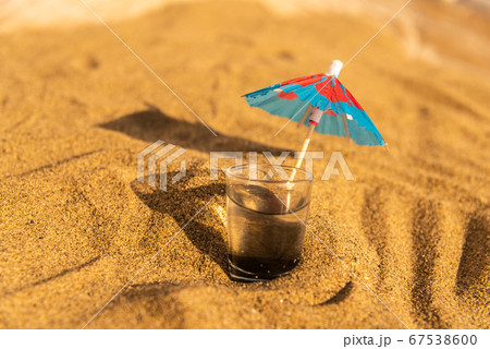 colorful shots drinks on a sandy beach with 67538600