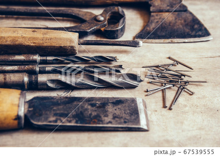 Old construction tools on a wooden workbench flat lay background. Carpenter table. Woodwork Old construction tools on a wooden workbench flat lay background. Carpenter table. Woodwork 67539555