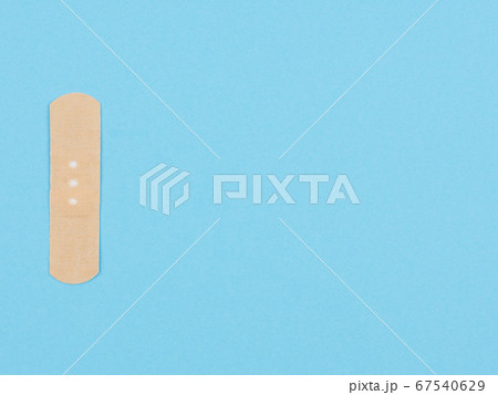 Band-aid on a blue background. 67540629