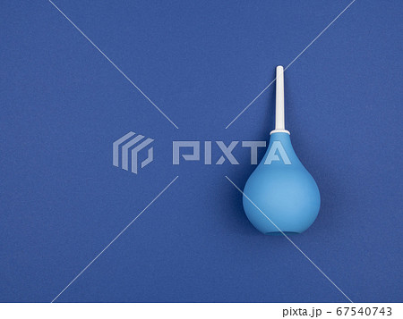 Enema bag on blue background. 67540743