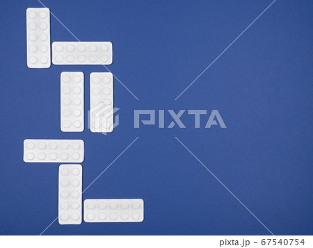 Tablets in blister packs on a blue background. Tablets in blister packs on a blue background. 67540754