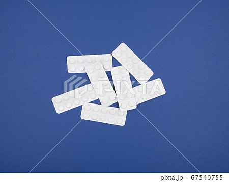 Blisters of pills on a blue background. Blisters of pills on a blue background. 67540755