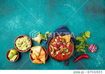 Mexican food concept background with chile black bean soup, guacamole and nachos totopos. Top view 67542655