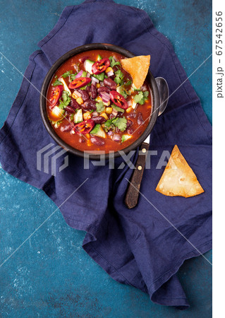 Mexican chile bean soup on blue background 67542656