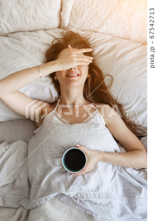 Female in bed drinking coffee. Happy girl. Morning concept. breakfirst in bed Female in bed drinking coffee. Happy girl. Morning concept. breakfirst in bed 67542713