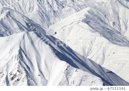 High mountains with sunlit snowy slope at cold 67551591