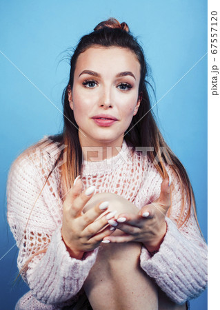 young pretty teenage modern hipster girl posing emotional happy on blue background, lifestyle people concept young pretty teenage modern hipster girl posing emotional happy on blue background, lifestyle people concept 67557120