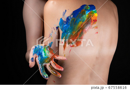 Image of woman messing up rainbow on nude back Image of woman messing up rainbow on nude back 67558616