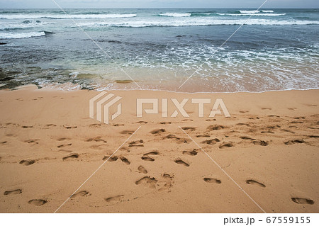 A lot of footprints or traces on sand beach  67559155