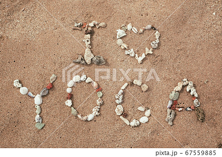 Writing with shells text Yoga on beach Writing with shells text Yoga on beach 67559885