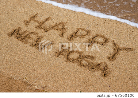 Inscription on sand seashore Happy New Yoga. 67560100