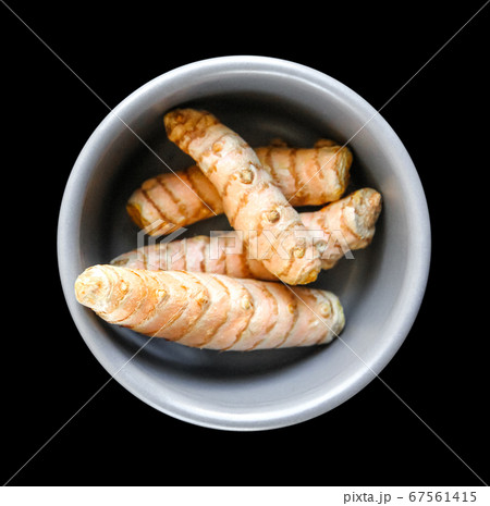 Turmeric root in a bowl isolated on black Turmeric root in a bowl isolated on black 67561415