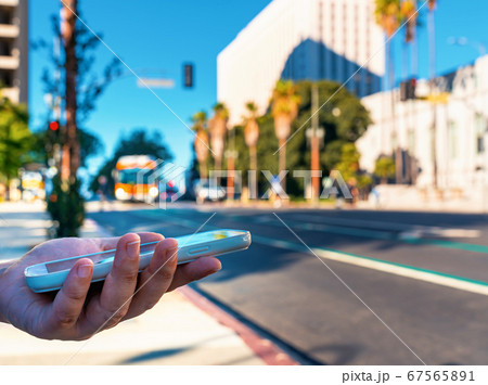 Woman using her smart phone in Downtown Los Angeles 67565891