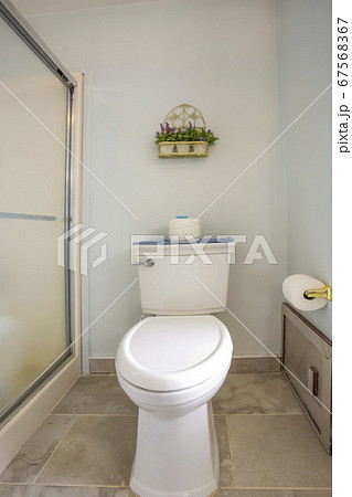 Toilet beside the shower stall inside the bathroom 67568367