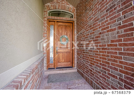 Rustic wooden door with wreath sidelight and 67568379