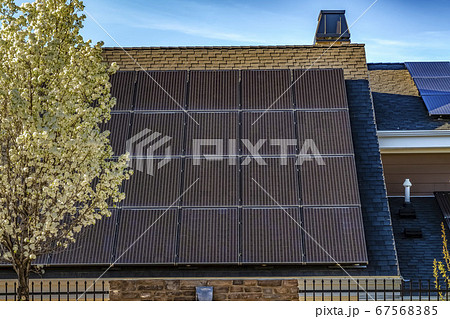 Solar panel on the dark pitched roof of a house Solar panel on the dark pitched roof of a house 67568385