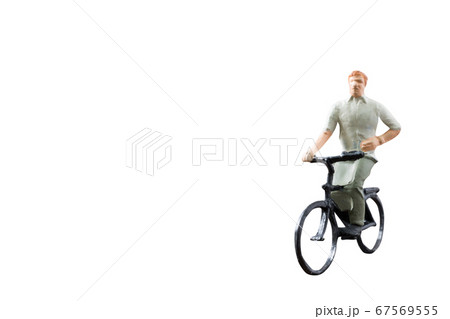 Miniature figure ride bicycle isolated on white background Miniature figure ride bicycle isolated on white background 67569555