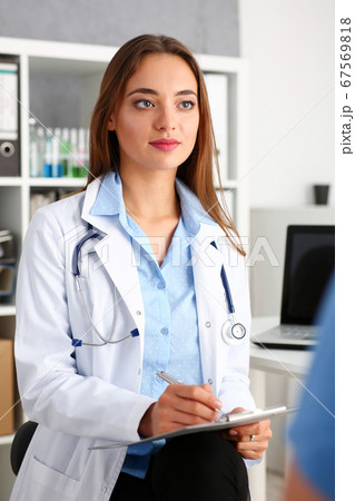 Female doctor hold hold in arm silver pen and pad Female doctor hold hold in arm silver pen and pad 67569818