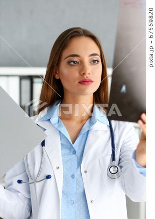 Beautiful female doctor hold in arm xray picture 67569820