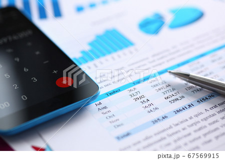 Smartphone calculator and financial statistics on infographics 67569915
