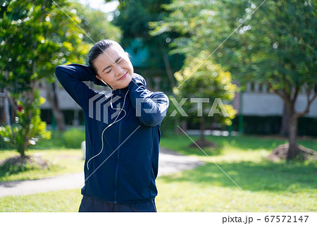 Portrait of Asian woman wearing earphones Portrait of Asian woman wearing earphones 67572147