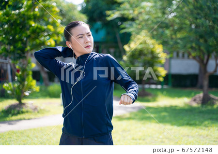 Portrait of Asian woman wearing earphones Portrait of Asian woman wearing earphones 67572148