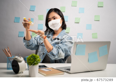 Asian woman wearing protective face mask washing 67573289