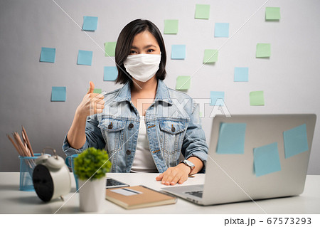 Asian woman wearing protective face mask happy and 67573293
