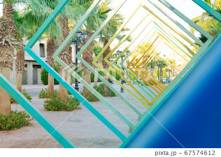 Abstract view of palm trees trough square perspective. Abstract view of palm trees trough square perspective. 67574612