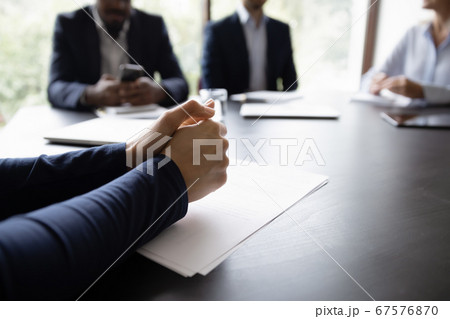 Businessman participates in meeting, put his hands on table closeup Businessman participates in meeting, put his hands on table closeup 67576870
