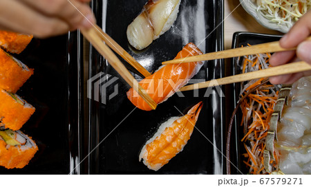 Hand holding chopstick for eat japan food Hand holding chopstick for eat japan food 67579271