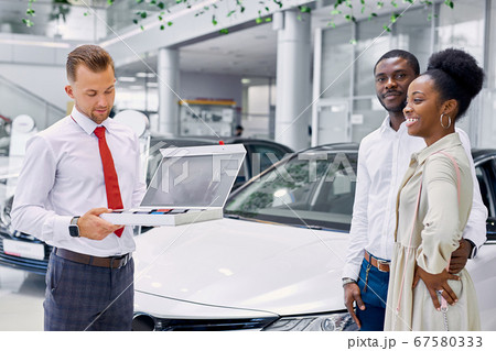 confident professional consultant show colour palette of cars to customers confident professional consultant show colour palette of cars to customers 67580333