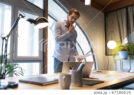 Pensive male employee busy brainstorming working in office 67580619