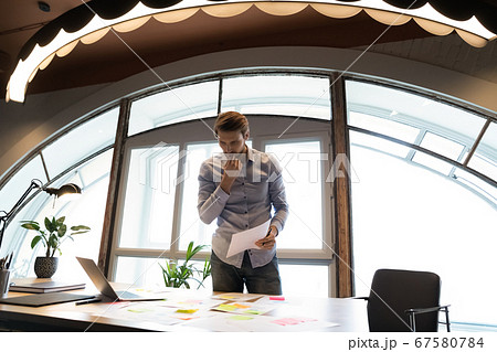 Pensive caucasian businessman analyze financial paperwork in office 67580784
