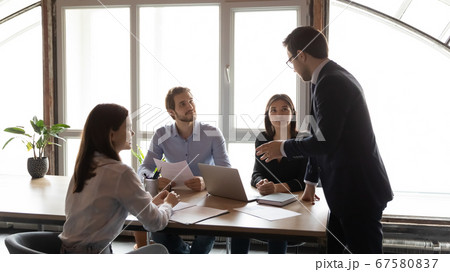 Motivated diverse employees work together in boardroom Motivated diverse employees work together in boardroom 67580837